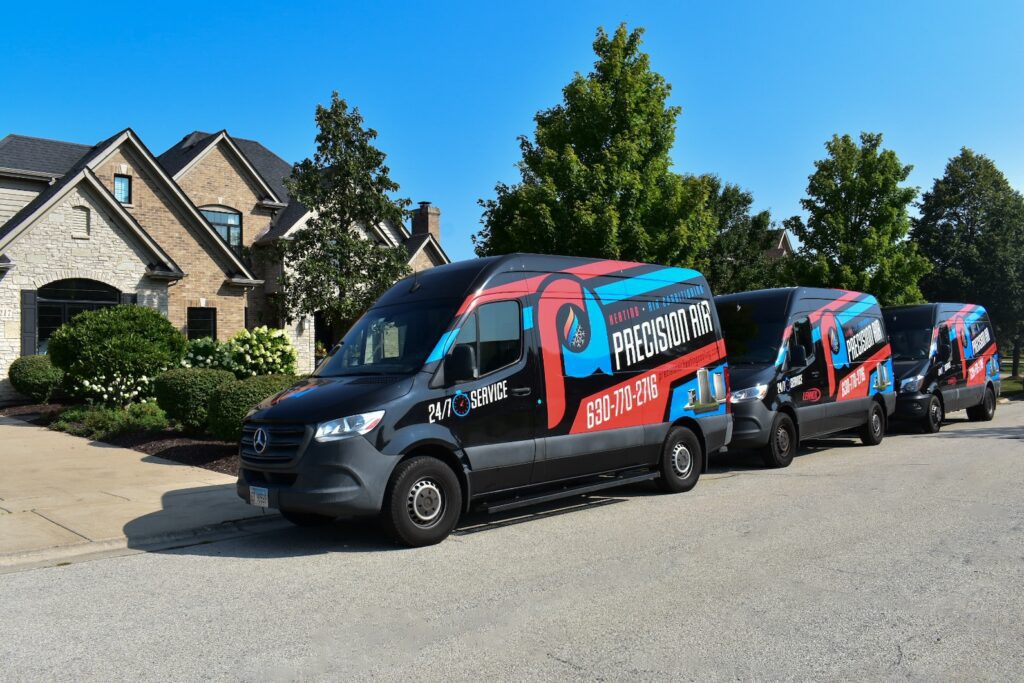 Precision Air company vans outside of residential home in Illinois
