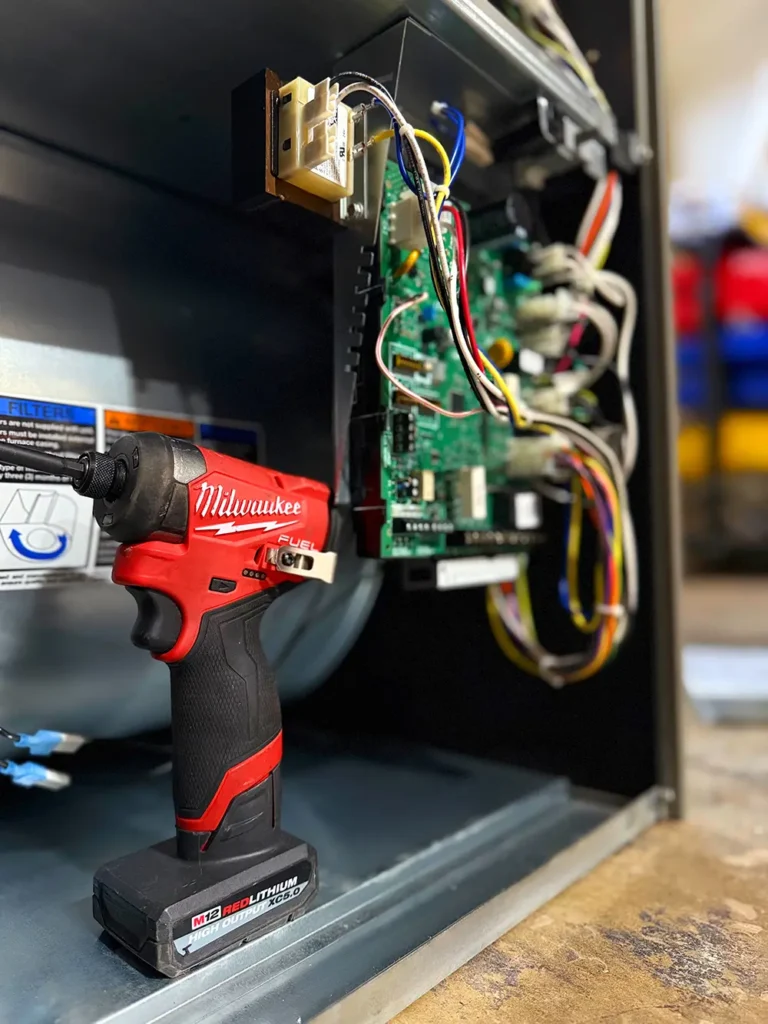 technician performing heating repair on furnace