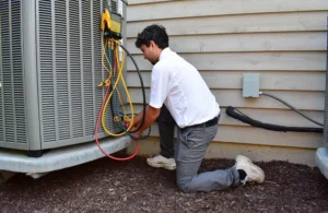 AC technician working on unit