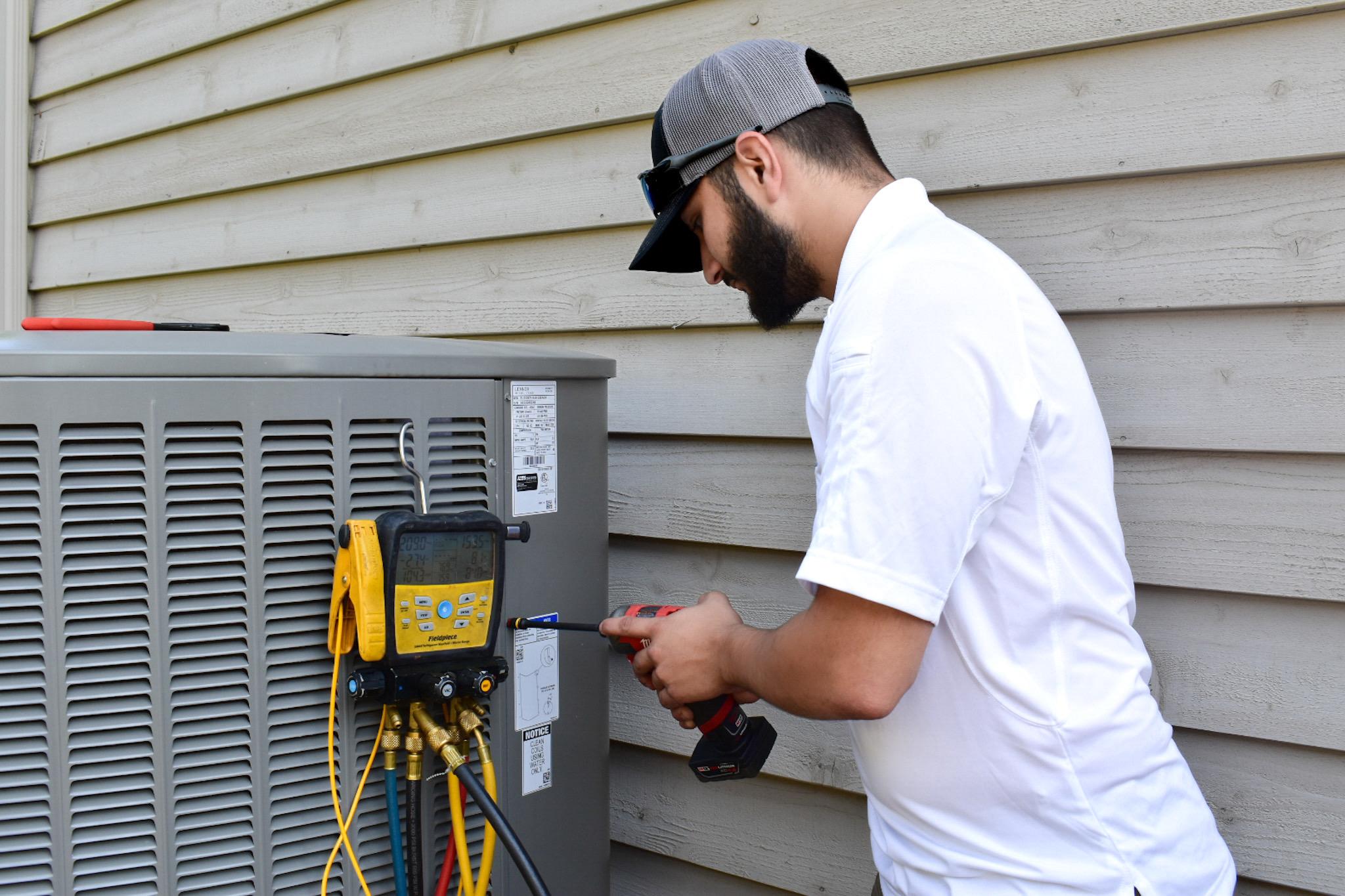 Precision Air technician repairing ac unit
