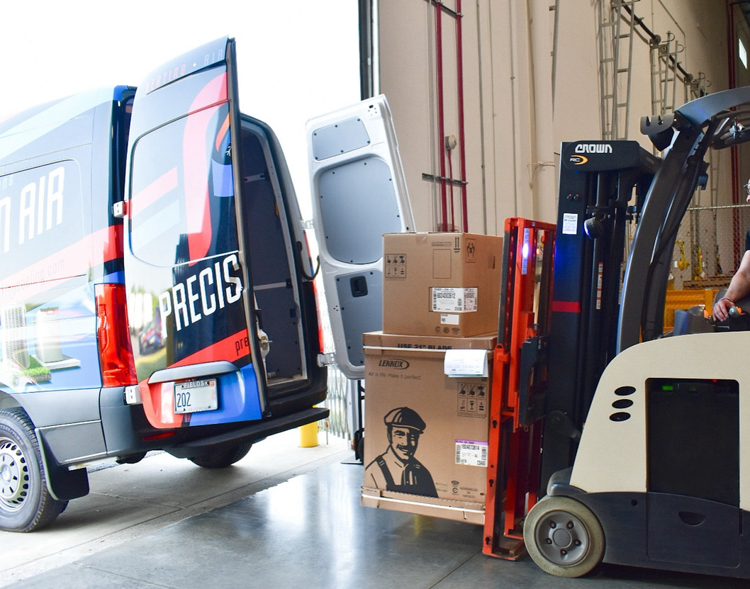 Precision Air service van loading new home furnace system to be installed
