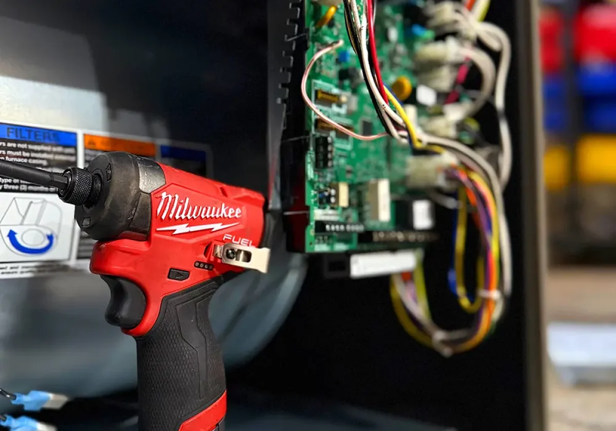 technician performing heating repair on furnace